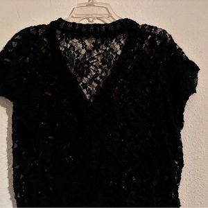 Black short sleeve knit top with lace like knit. Knit with rose like lace design